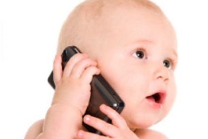 baby holding mobile phone to ear