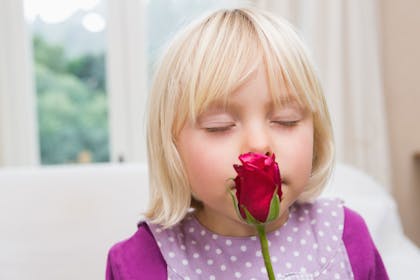 Girl smelling flower