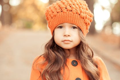 little girl wearing orange wooly hat