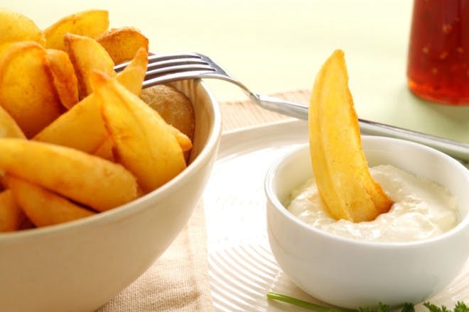 Bowl of potato wedges and creamy dip