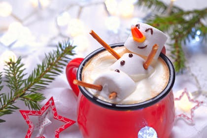 Marshmallow snowman in a mug of hot chocolate
