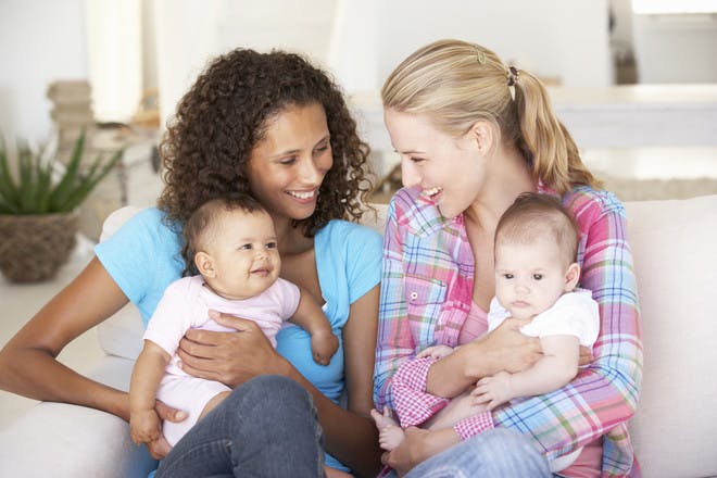 two woman and their babies