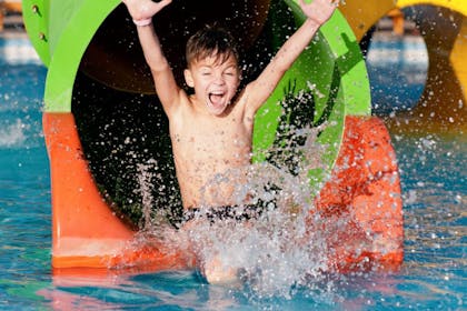 child going down slide at Splash World