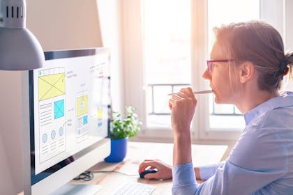 Woman designing website on desktop
