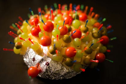 Cheese and pineapple hedgehog with olives, grapes and tomatoes