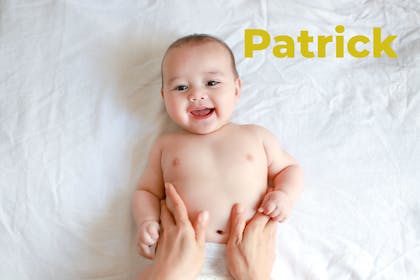 Baby smiling, mum's hands on tummy. Name Patrick written in text