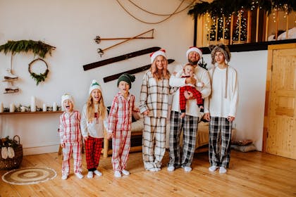 Family at Christmas wearing Santa hats and pyjamas