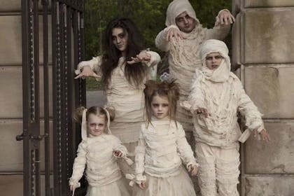 A family dressed as mummies