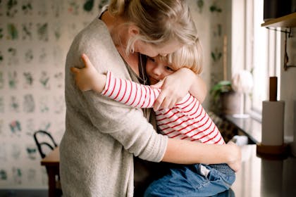 Mum hugging toddler child