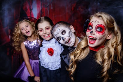 Kids in halloween costumes in a spooky room