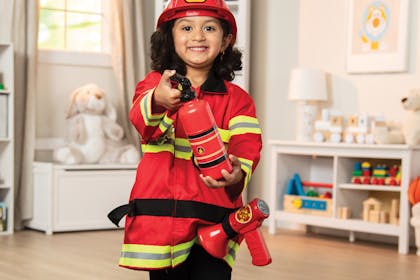 girl dressed in Melissa & Doug fireman set