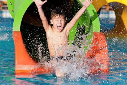 Boy going down water slide