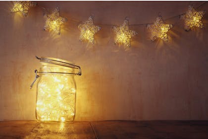 fairy lights on a wall and in a mason jar