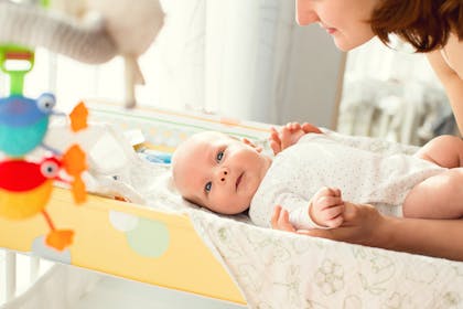 baby on changing mat