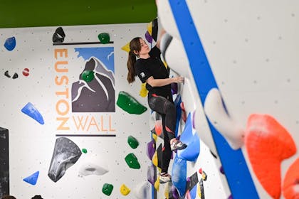 A girl concentrates on her next move at Euston Wall, a London Climbing Centre