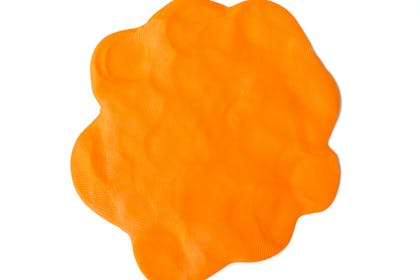 Orange play dough against white background 