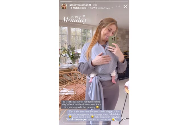 Stacey Solomon holding baby Belle in a sling