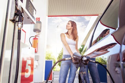 Woman putting petrol into car