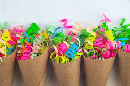 Brown paper cones filled with colourful party ribbons