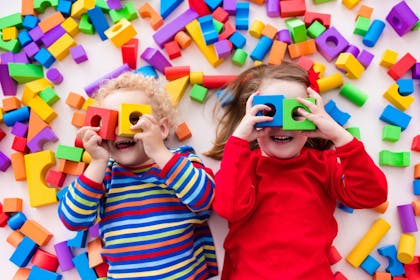 Kids looking through blocks with holes