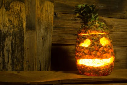 Carved pineapple Jack-o-lantern for Halloween