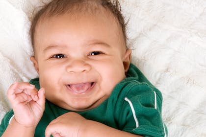 Boy laughing in green top