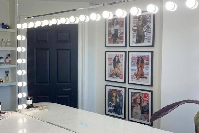 Rochelle Humes' dressing room with her dressing table and magazine covers on the wall. 
