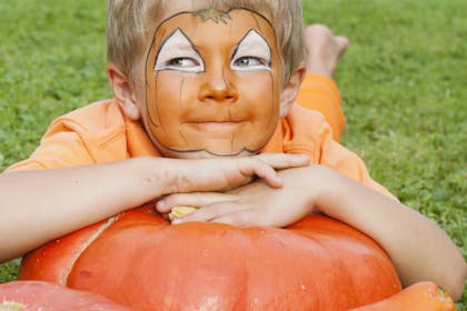 Halloween face paint for a cute pumpkin