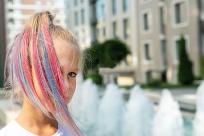 Young girl with pink and blue streaks in her hair