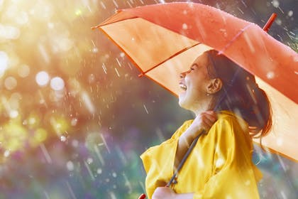 child in rain with umbrella