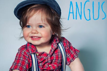 baby wearing red tartan shirt and blue cap