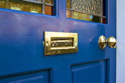 Close up of blue front door with letter box