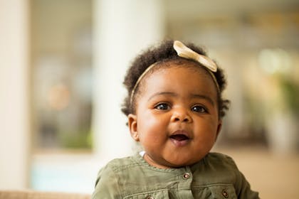 Happy baby with bow on her head 