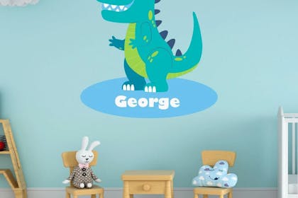 'George' name and dinosaur wall sticker in boy's bedroom.