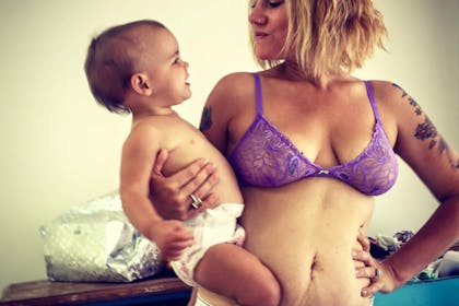 Mum in bra holding baby