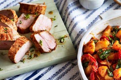 Roast pork with spicy potatoes, spinach and tom