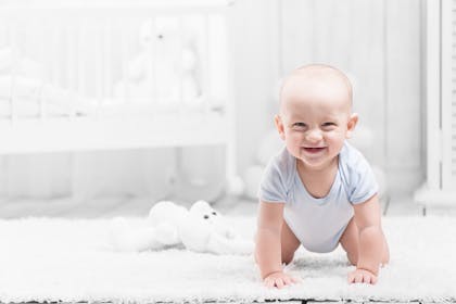 Baby crawling on all fours and smiling