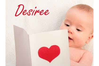 baby looking at card with heart on it