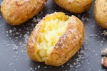Jacket potatoes with fluffy middles and sprinkled with salt made in an air fryer