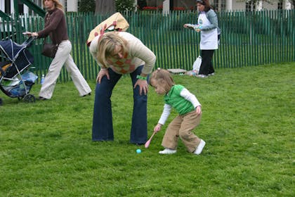 Child and mother egg rolling