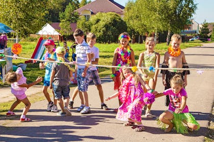 kids limbo dancing in colourful costumes