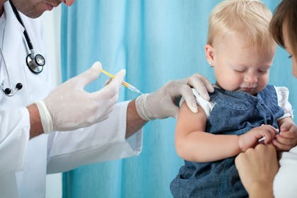One year old baby getting an injection from a doctor