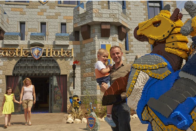 Family outside Legoland Castle Hotel with Lego Knight on horse