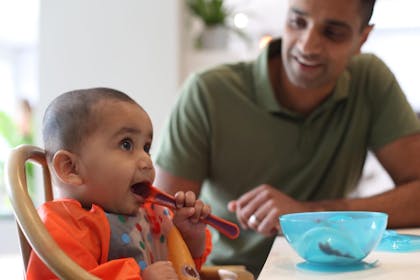 Baby eating with dad