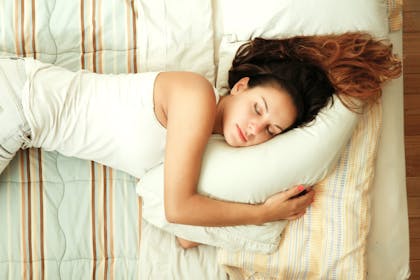 woman sleeping on white pillow