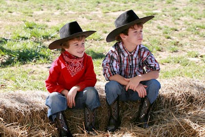 Two little boys dressed as cowboys