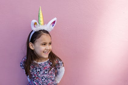 Young girl wearing unicorn headband