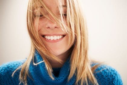 woman in blue jumper smiling