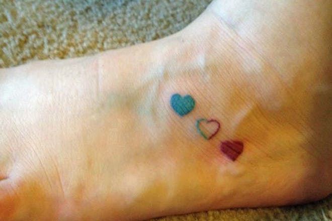 Ankle tattoo of three hearts to represent miscarriage
