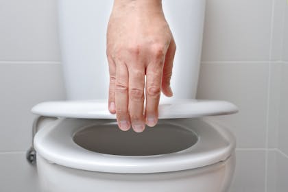 Hand lifts toilet lid